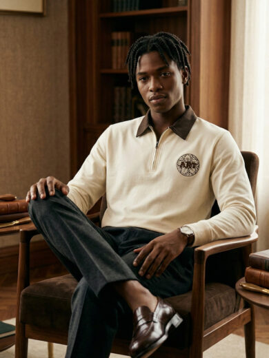 Vintage Crest Quarter-Zip Knit Polo in off-white featuring a contrasting brown collar, quarter-zip closure, and crest embroidery on the chest.